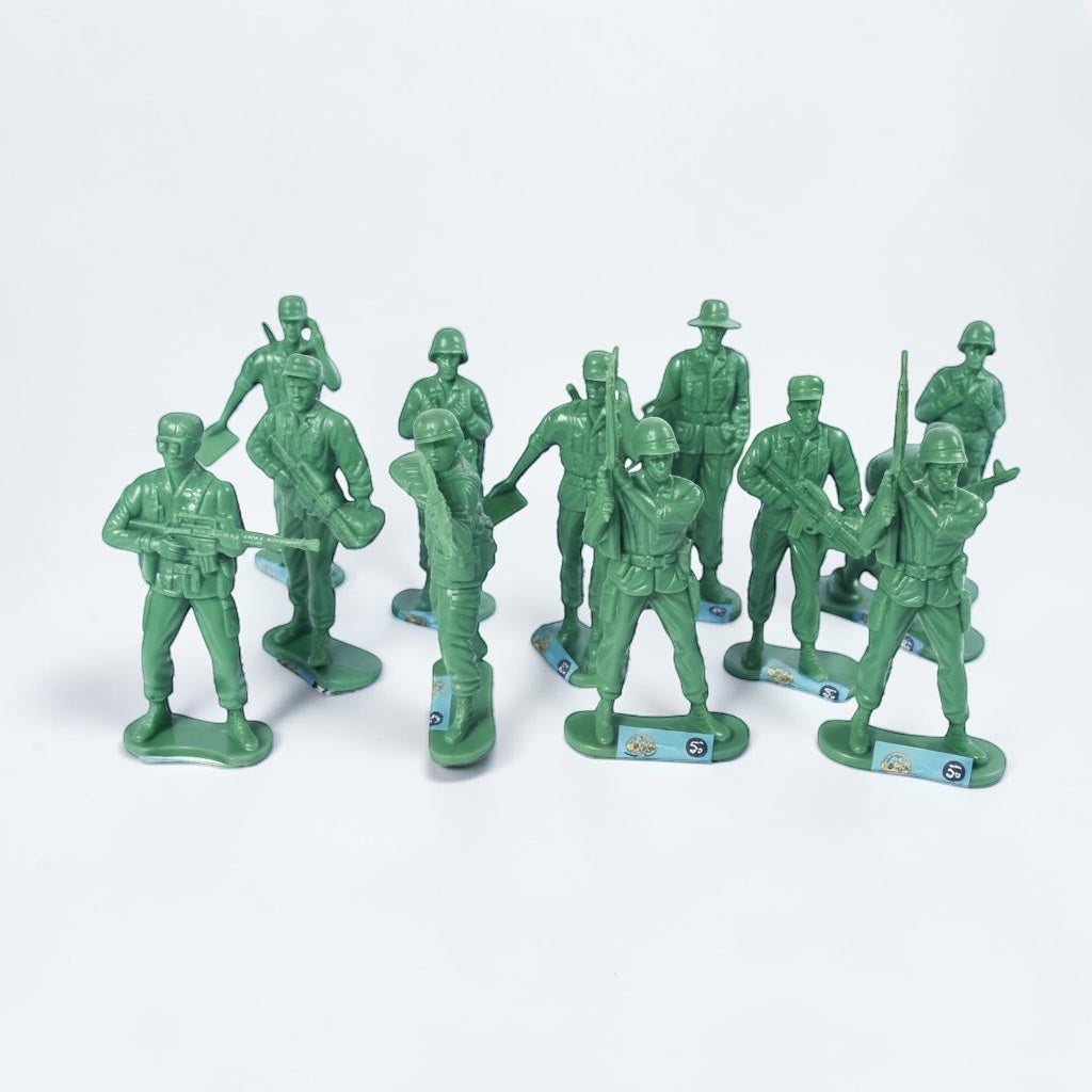 Outrageous Art set of green plastic toy soldier figurines in various action poses on a white background.