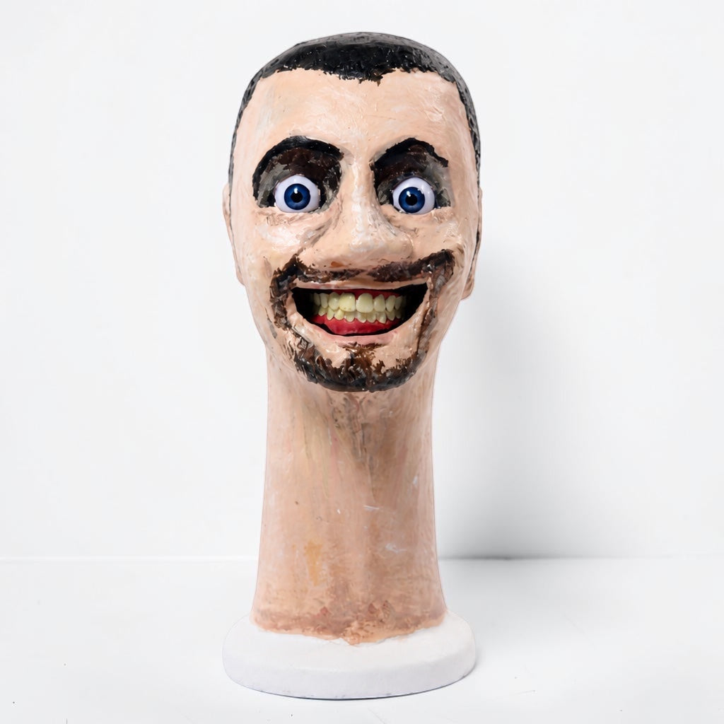 Outrageous Art Skibidi Toilet sculpture featuring a realistic human head with wide eyes and a grinning mouth.