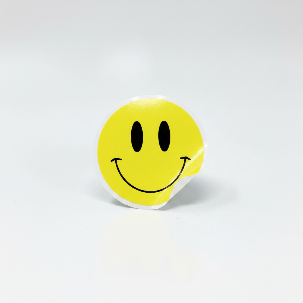 Outrageous Art yellow smiley face sticker with a playful design, perfect for laptops and water bottles.