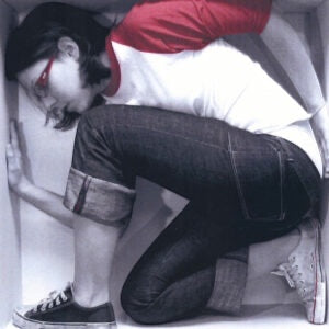 Outrageous Art Ali Spagnola CD cover featuring a woman in a white and red shirt crouched inside a white box