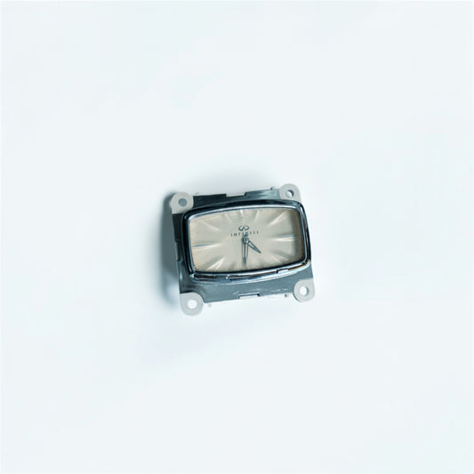 Outrageous Art analog car clock with a cream face and chrome bezel, isolated on a white background.