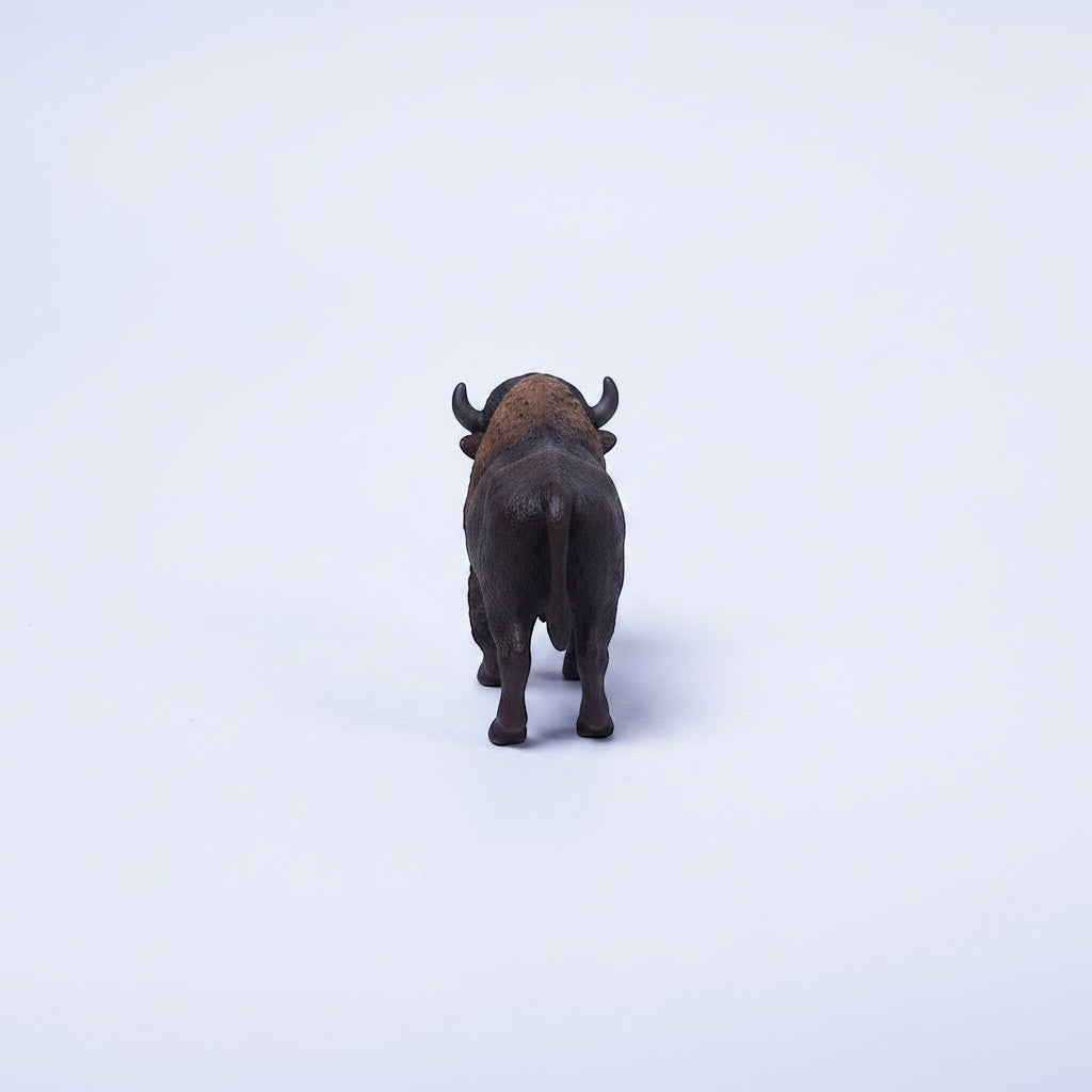 Outrageous Art miniature bison figurine showing realistic brown fur texture and horns from a rear view