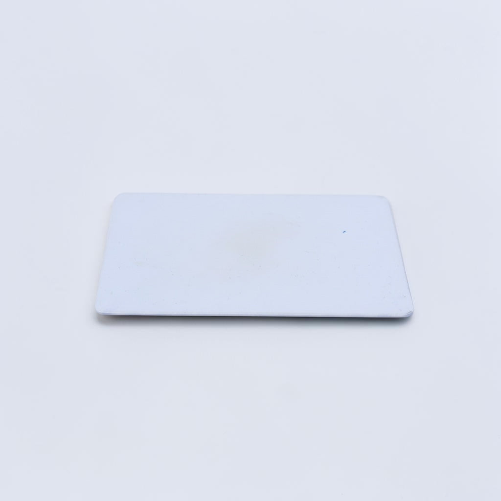 Outrageous Art blank white PVC identification card with a smooth, durable rectangular surface for professional printing.