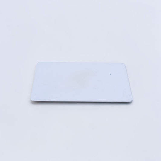 Outrageous Art blank white PVC identification card with a smooth, durable rectangular surface for professional printing.