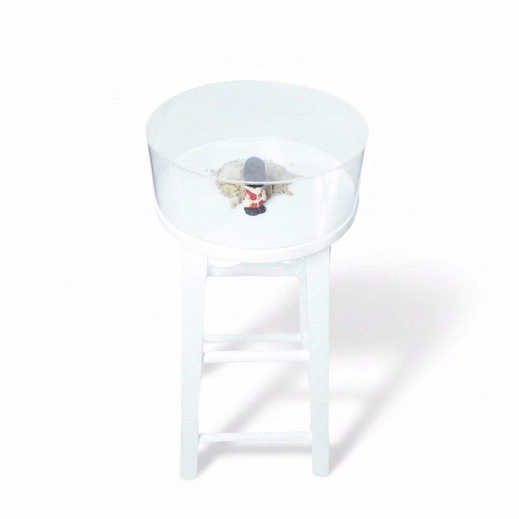 Outrageous Art British Land Stool featuring a white stool with a glass display top containing a toy soldier and soil.
