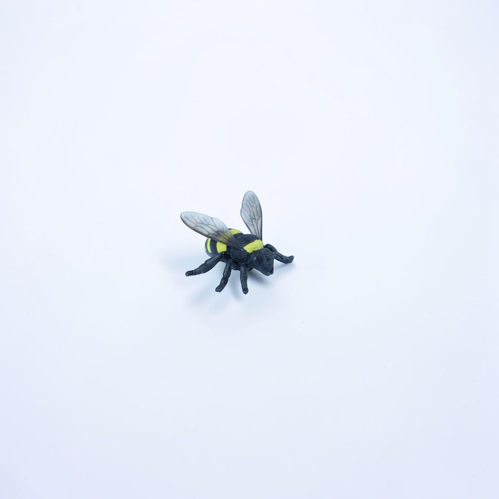 Outrageous Art bumblebee mini figure with realistic black and yellow stripes and translucent wings on a white background