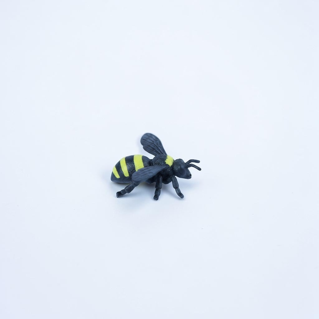 Outrageous Art bumblebee mini figure with realistic black and yellow striped pattern on a plain white background