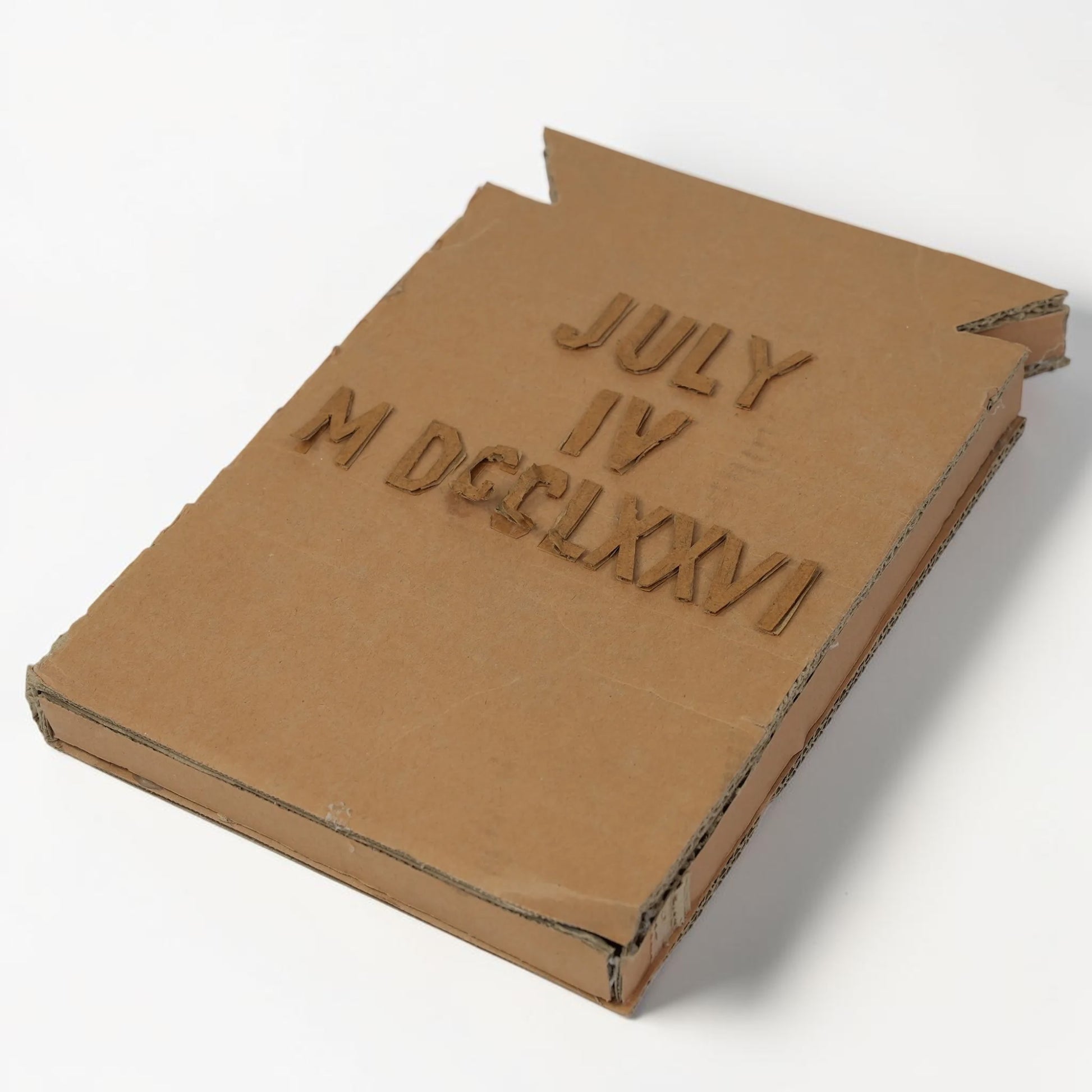 Outrageous Art handcrafted cardboard wall art featuring July 4 1776 in standard and Roman numerals with 3D texture.