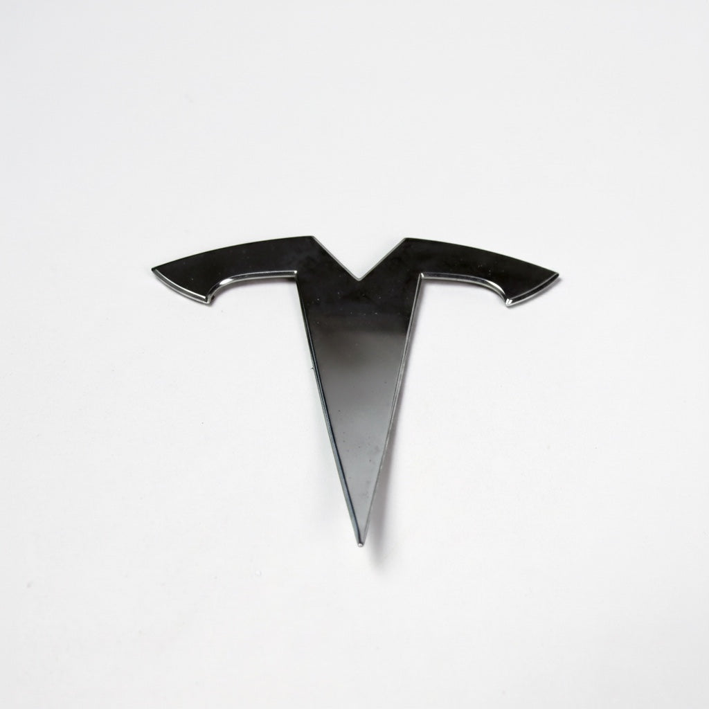 Outrageous Art chrome-finish T-logo automotive emblem with a sleek, reflective, and weather-resistant design.