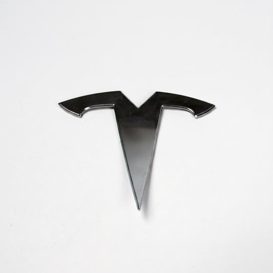 Outrageous Art chrome-finish T-logo automotive emblem with a sleek, reflective, and weather-resistant design.
