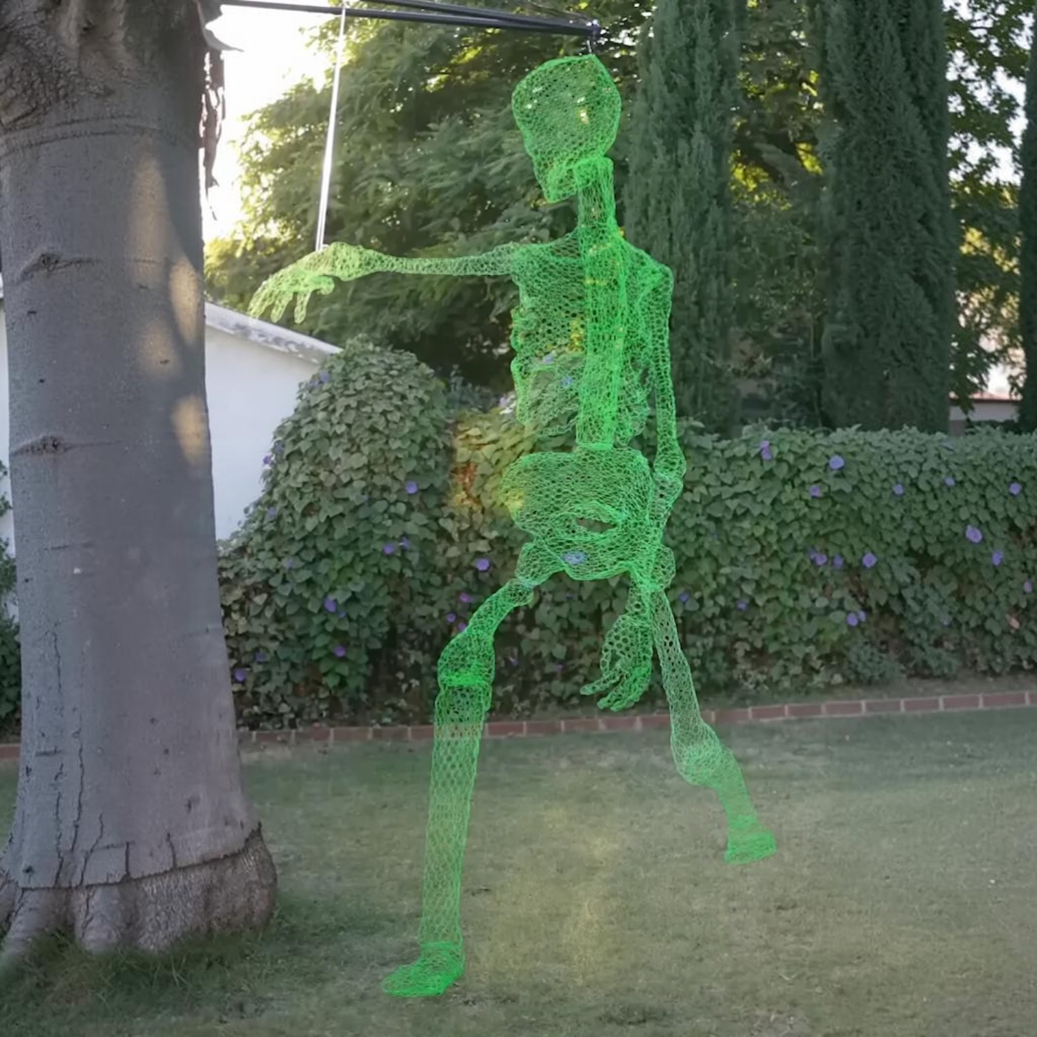 Outrageous Art 12-foot glowing green wire mesh ghost skeleton hanging in a garden for Halloween decoration