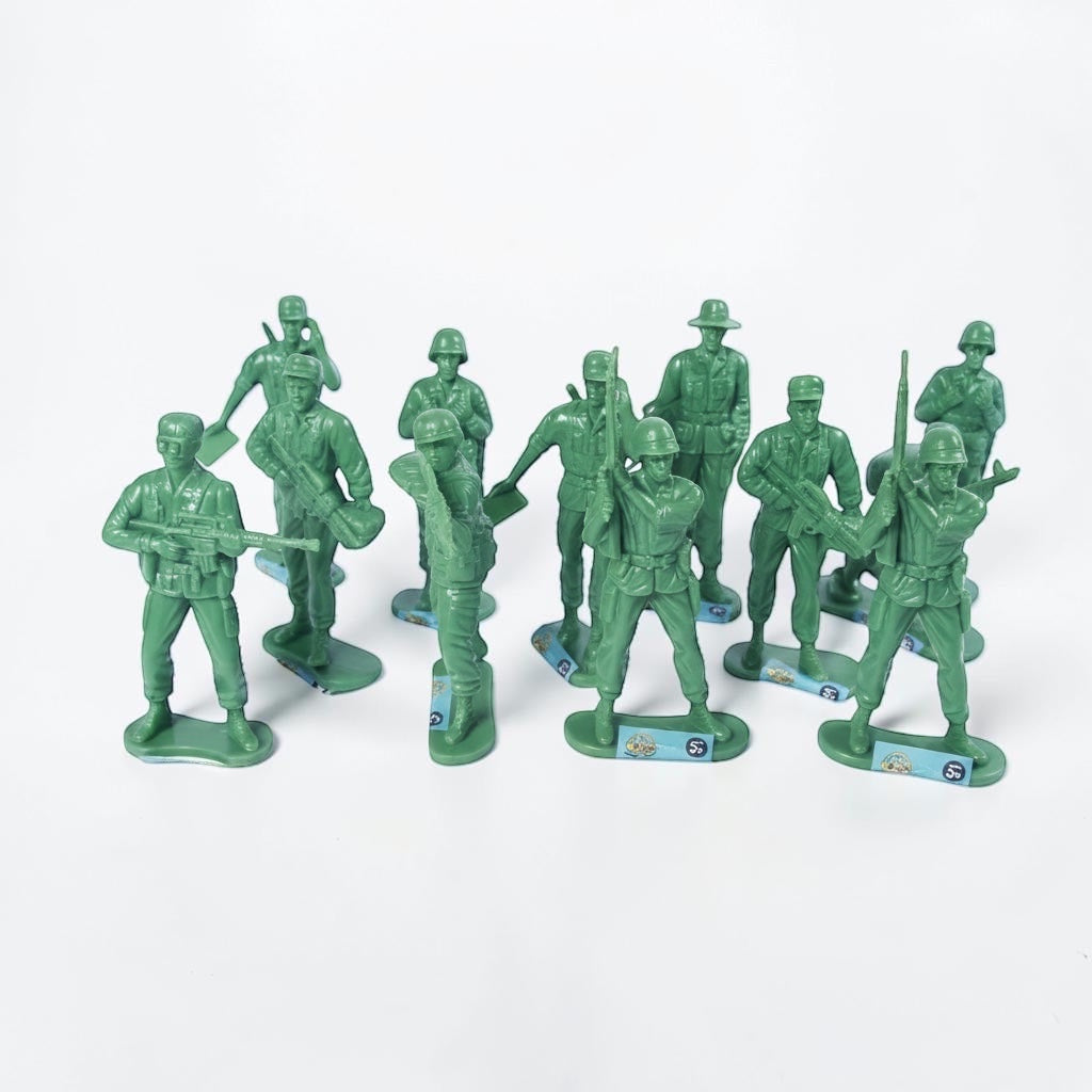 Outrageous Art set of classic green plastic army men in various combat poses for imaginative play.
