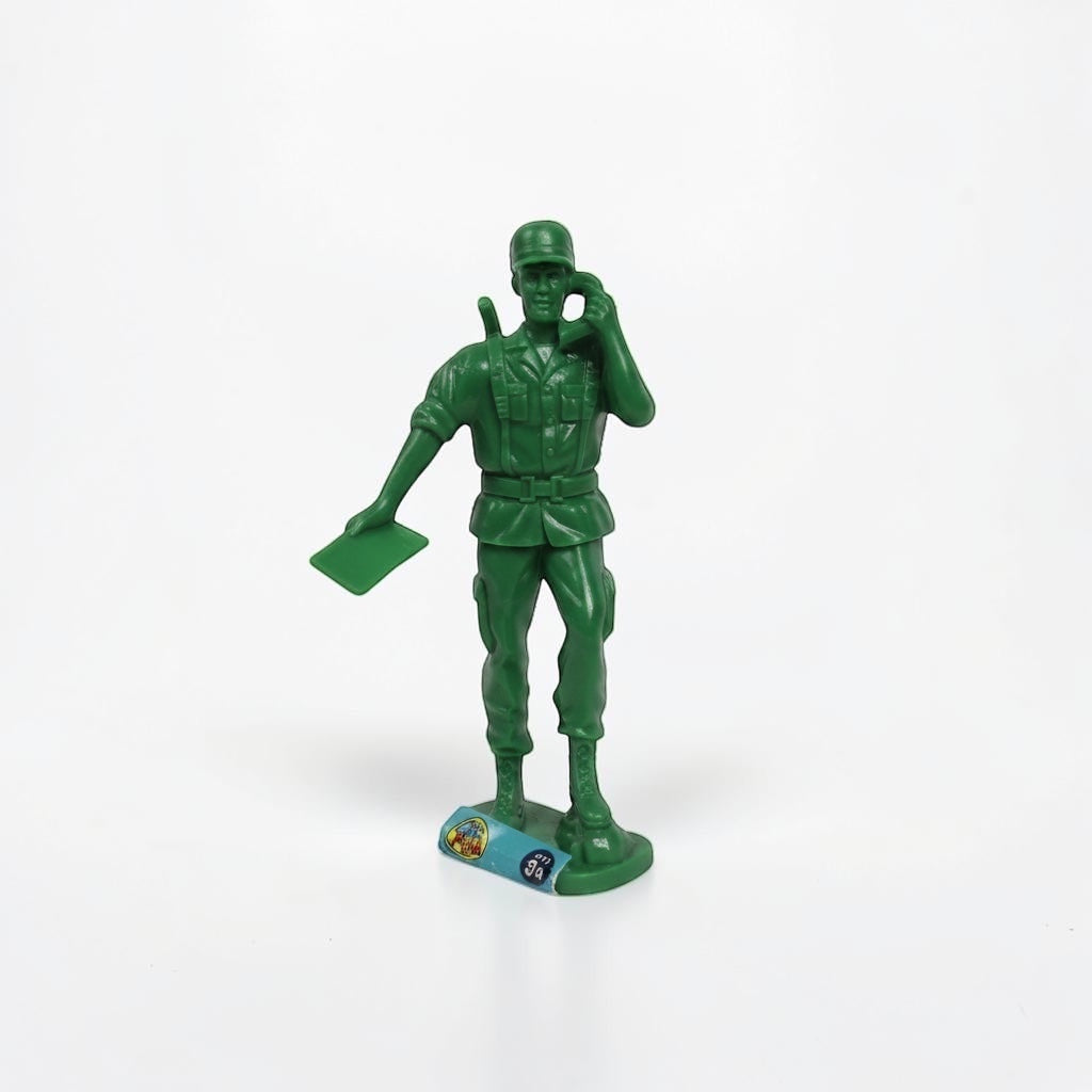 Outrageous Art green plastic toy soldier figure holding a radio and map on a white background