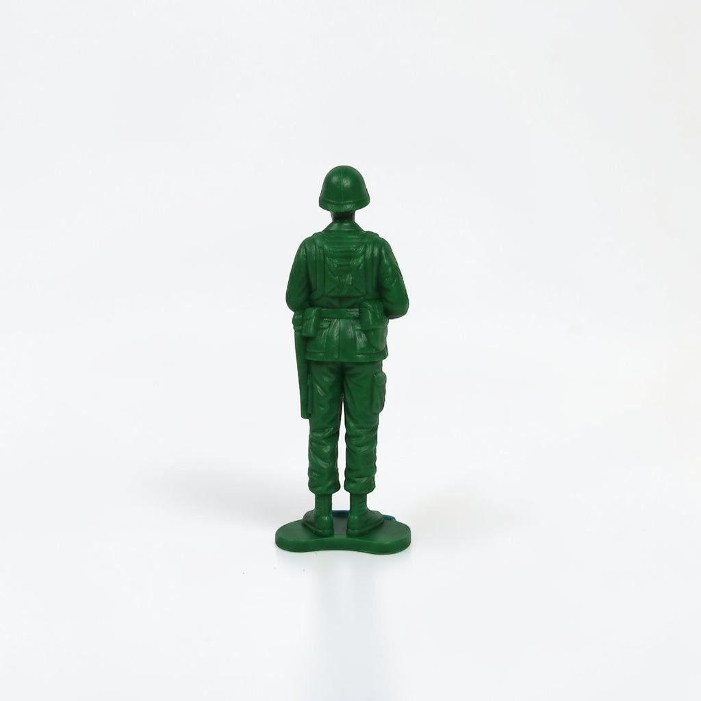 Outrageous Art classic green plastic miniature soldier action figure in a standing pose, back view