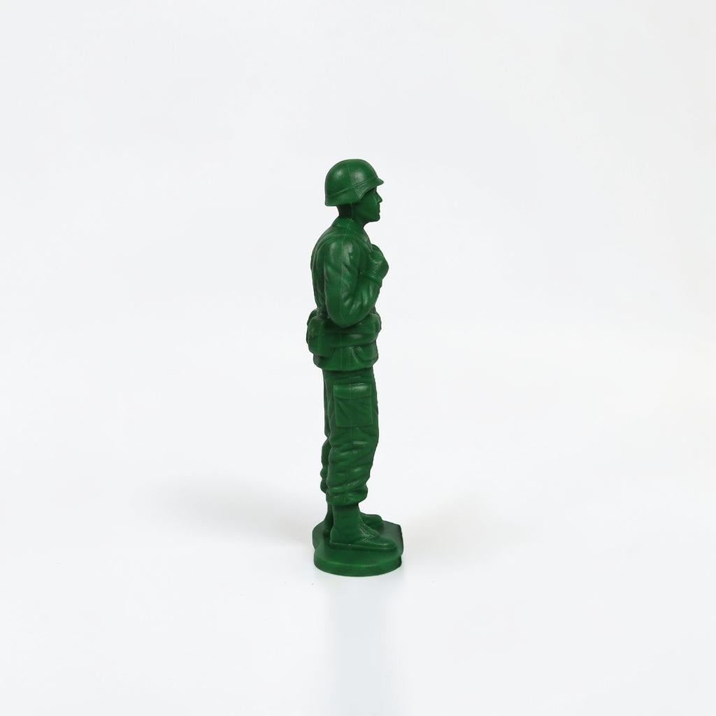 Outrageous Art green plastic miniature soldier action figure in a standing pose on a white background