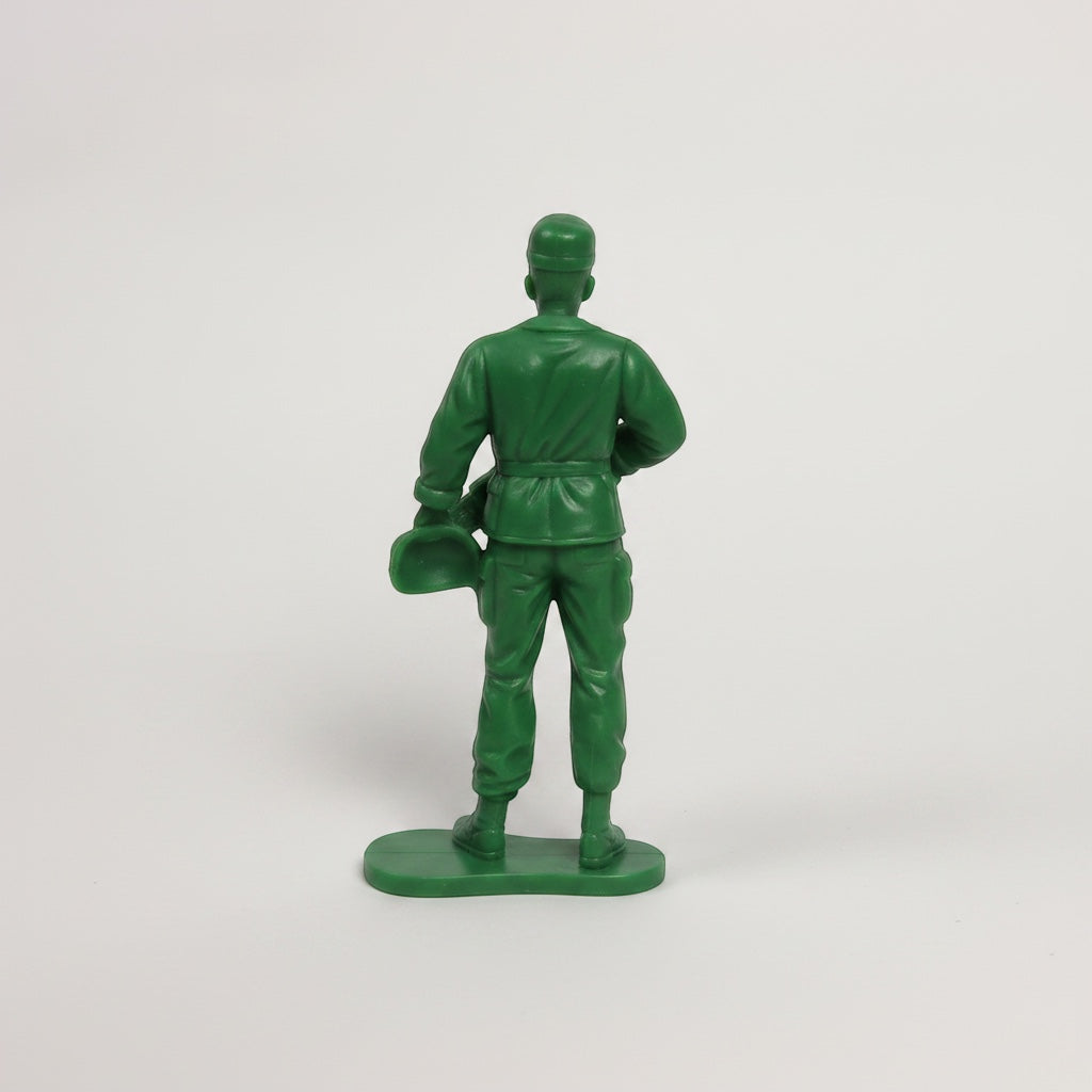 Outrageous Art green plastic toy soldier action figure viewed from the back standing on a sturdy base