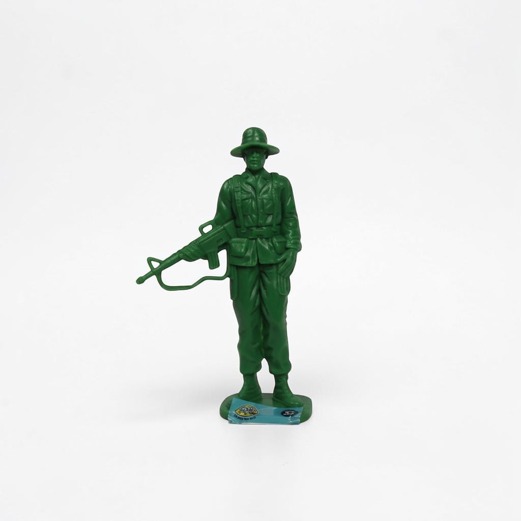 Outrageous Art green plastic toy soldier figurine with a rifle and wide-brimmed hat standing on a stable base