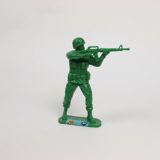 Outrageous Art classic green plastic toy soldier infantry figurine in a standing firing pose on a white background