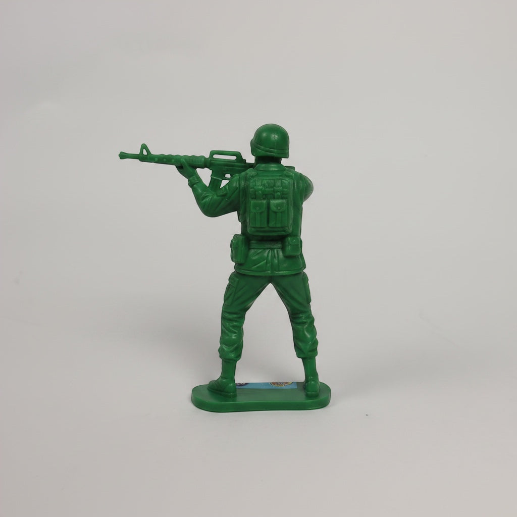 Outrageous Art green plastic toy soldier infantry figurine standing in a firing pose on a sturdy base
