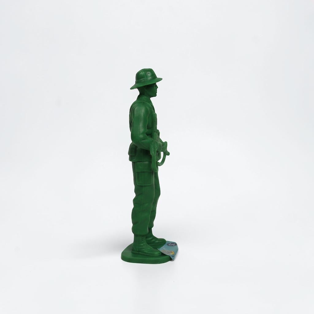 Outrageous Art green plastic toy soldier figurine in a standing pose with a rifle and wide-brimmed hat