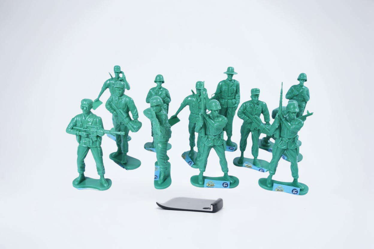 Outrageous Art set of green plastic toy soldier infantry figurines in various military poses on a white background
