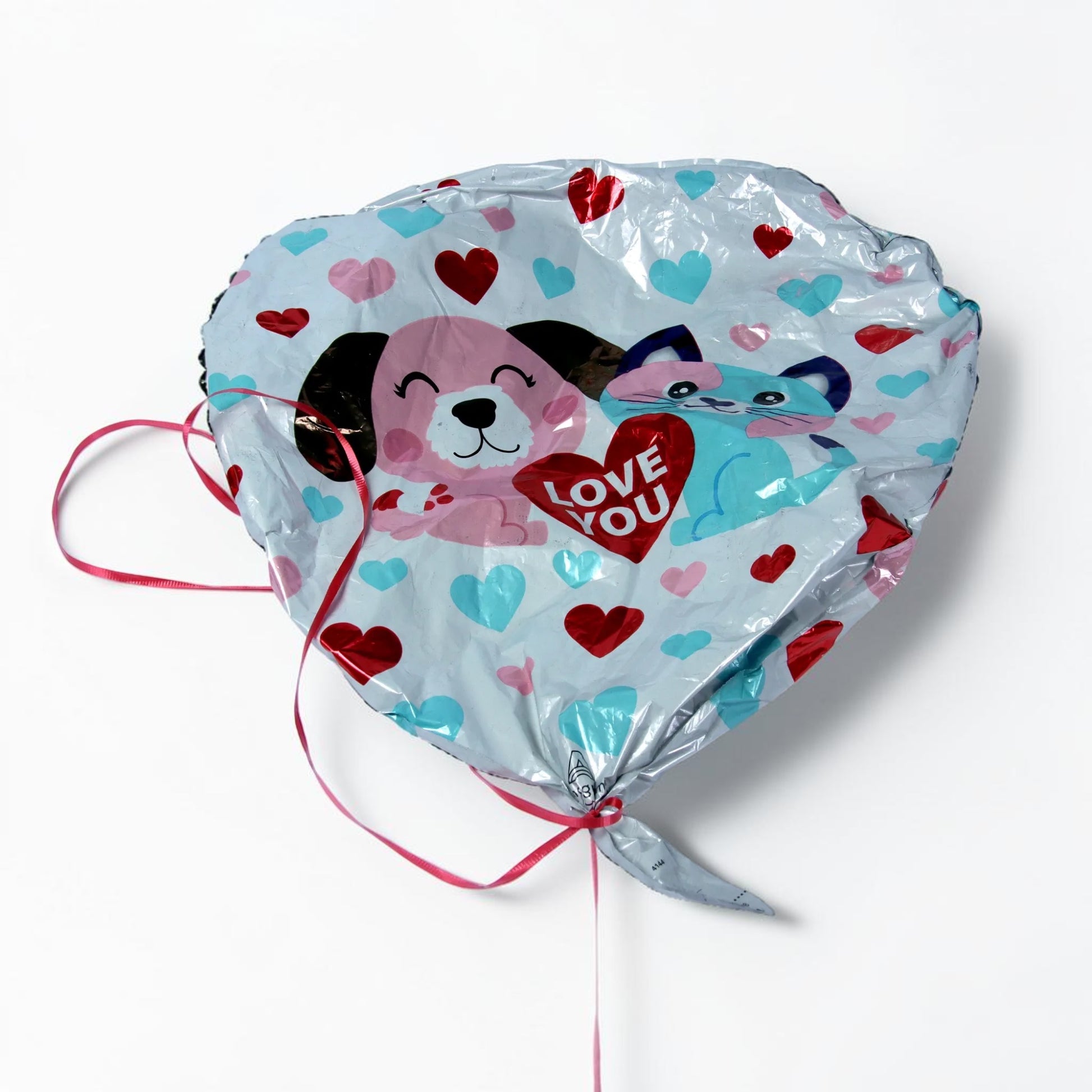 Outrageous Art heart-shaped foil balloon with puppy and kitten print, red and blue hearts, and LOVE YOU text with ribbon