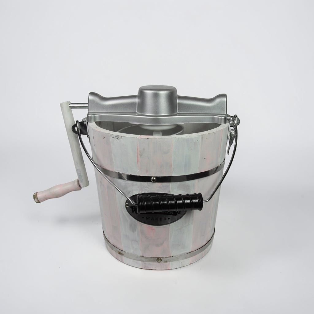 Outrageous Art traditional manual ice cream maker with a distressed white and pink wooden bucket and silver metal crank.