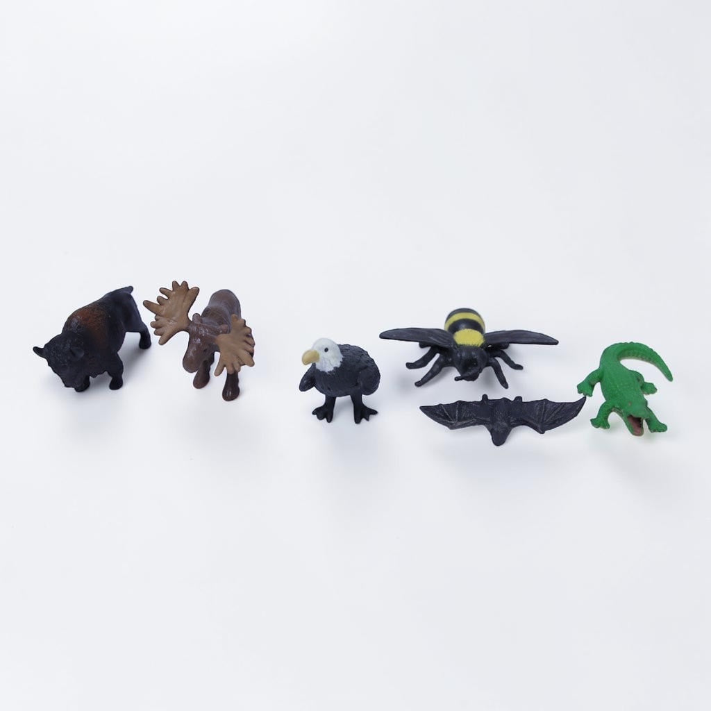 Outrageous Art miniature wild animal figurine set including a bison, moose, bald eagle, bee, bat, and alligator.