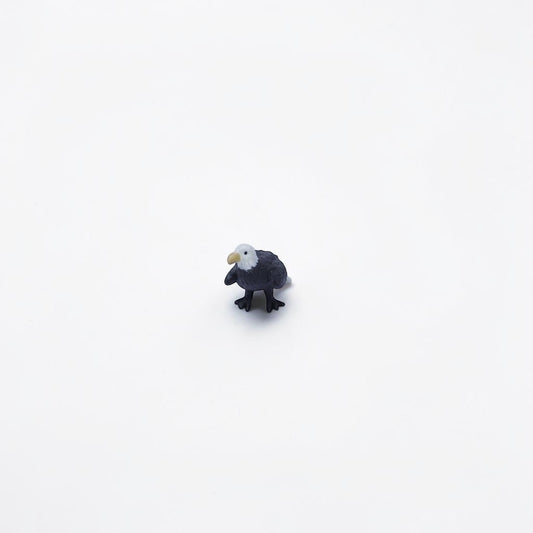 Outrageous Art miniature bald eagle figurine with realistic white head and dark brown body on a white background