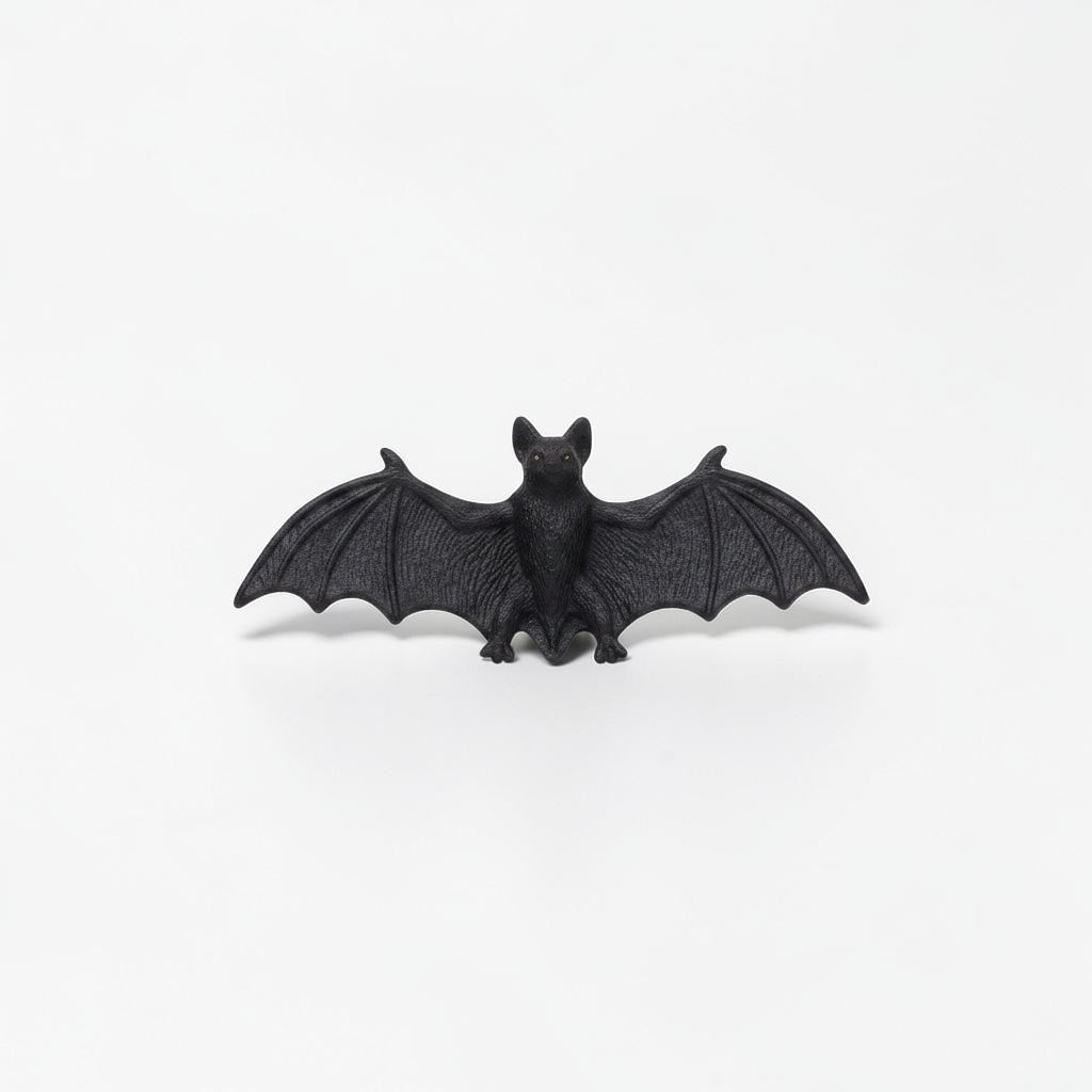 Outrageous Art miniature black bat figurine with detailed wings and realistic texture on a white background