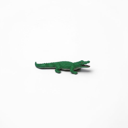Outrageous Art miniature green alligator figurine with detailed scales and open mouth on a white background