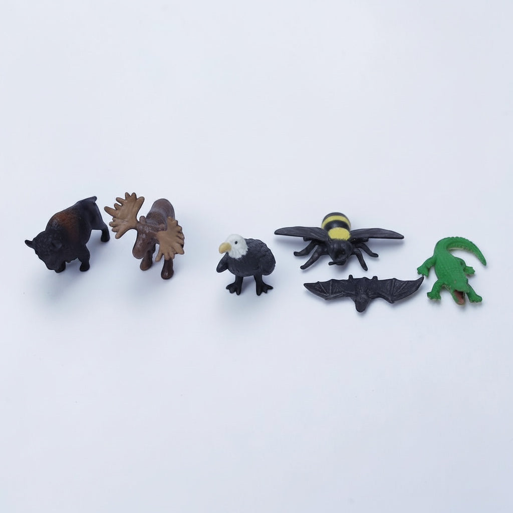 Outrageous Art miniature wildlife figurine set including a bison, moose, bald eagle, honeybee, bat, and alligator.