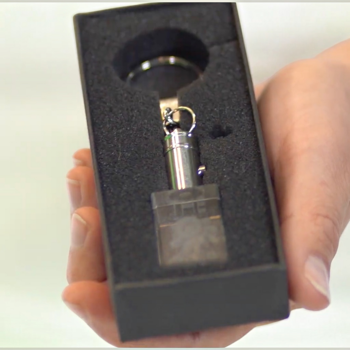 Outrageous Art O Club Keychain featuring a clear rectangular block and polished metal hardware in a black gift box.