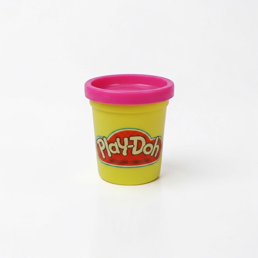Outrageous Art Play-Doh modeling compound in a yellow container with a bright pink lid against a white background