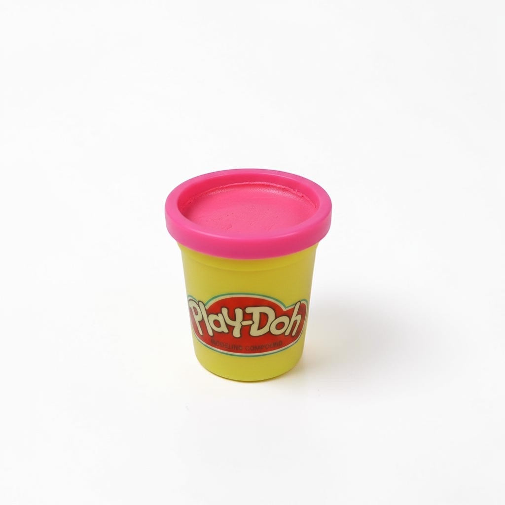 Outrageous Art Play-Doh modeling compound in a yellow container with a bright pink lid on a white background