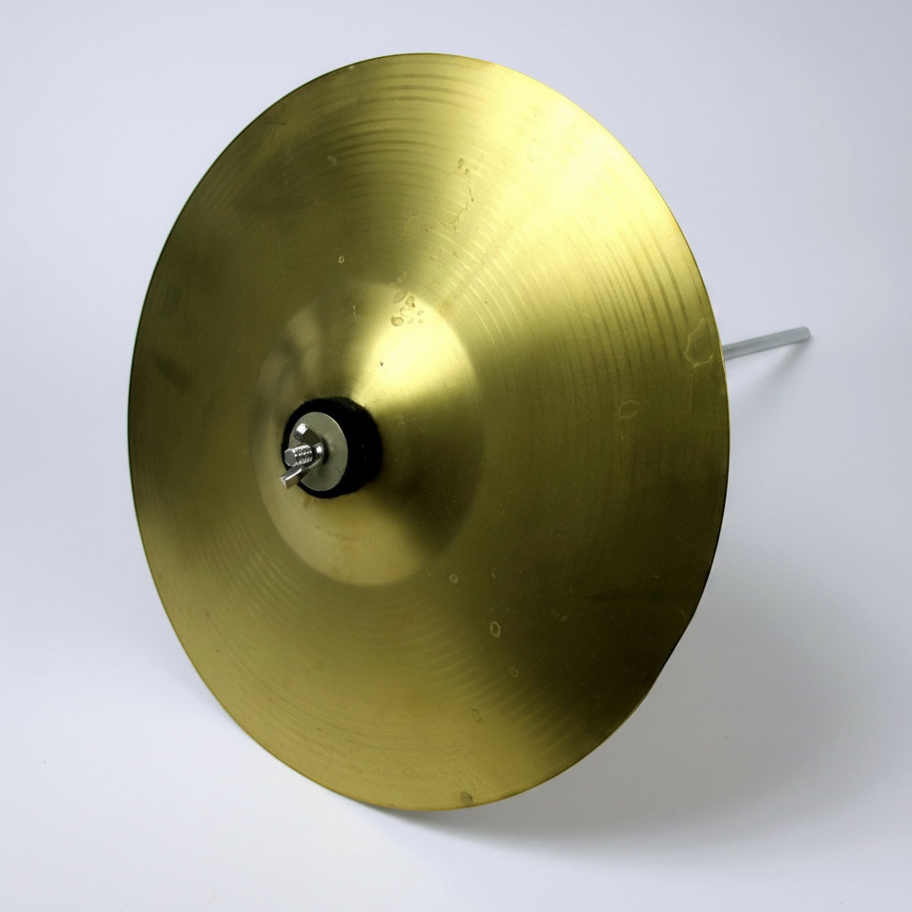 Outrageous Art professional brass cymbal with a classic gold finish, mounted on a stand for percussion performance.