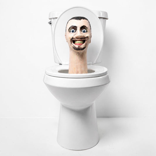 Outrageous Art Skibidi Toilet life-sized sculpture featuring a grinning human head emerging from a white ceramic toilet.