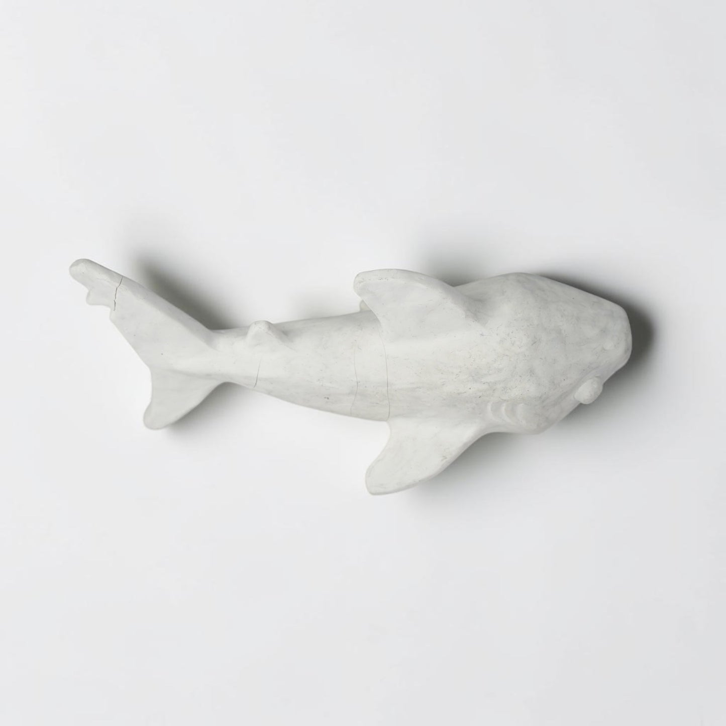 Outrageous Art handcrafted matte white shark sculpture with a minimalist silhouette for coastal home decor.