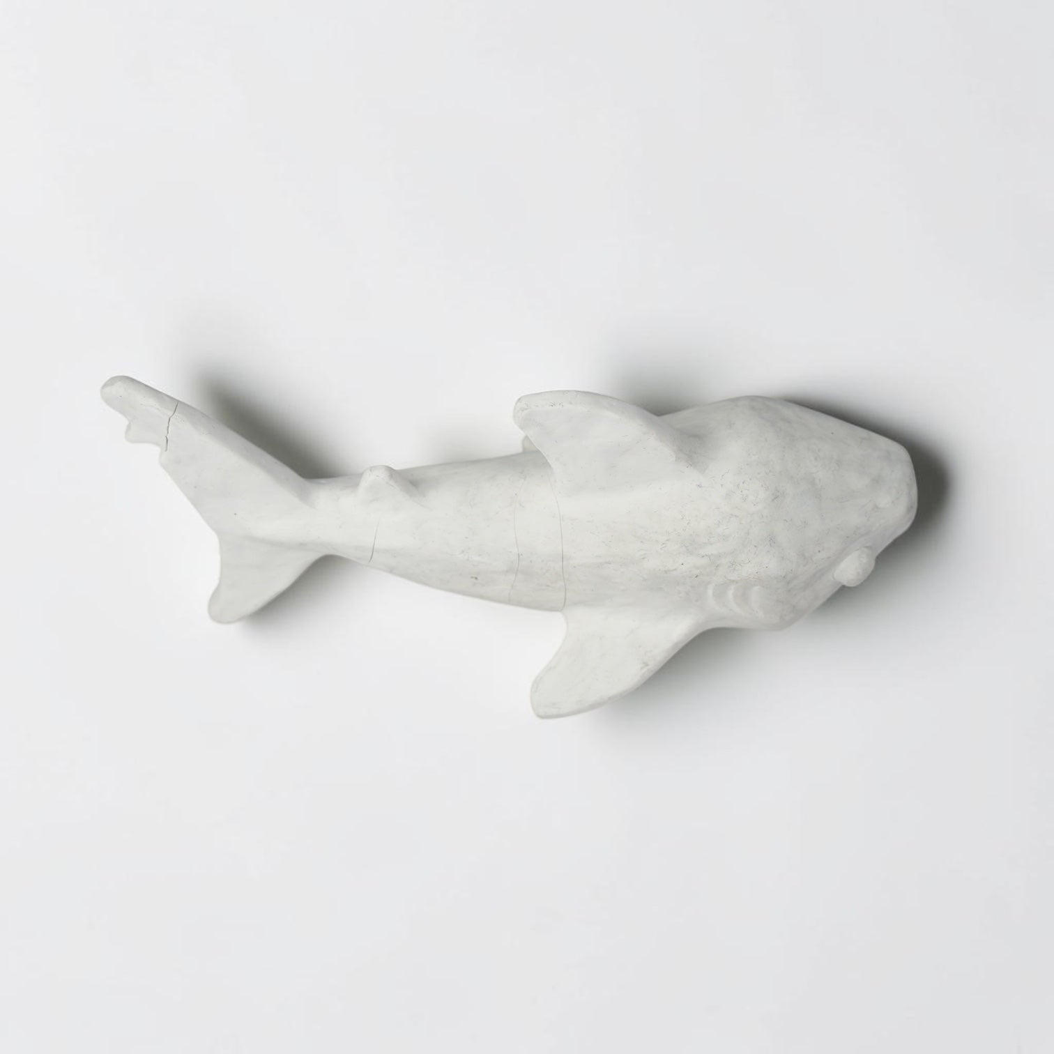 Outrageous Art handcrafted matte white shark sculpture with a minimalist silhouette for coastal home decor.