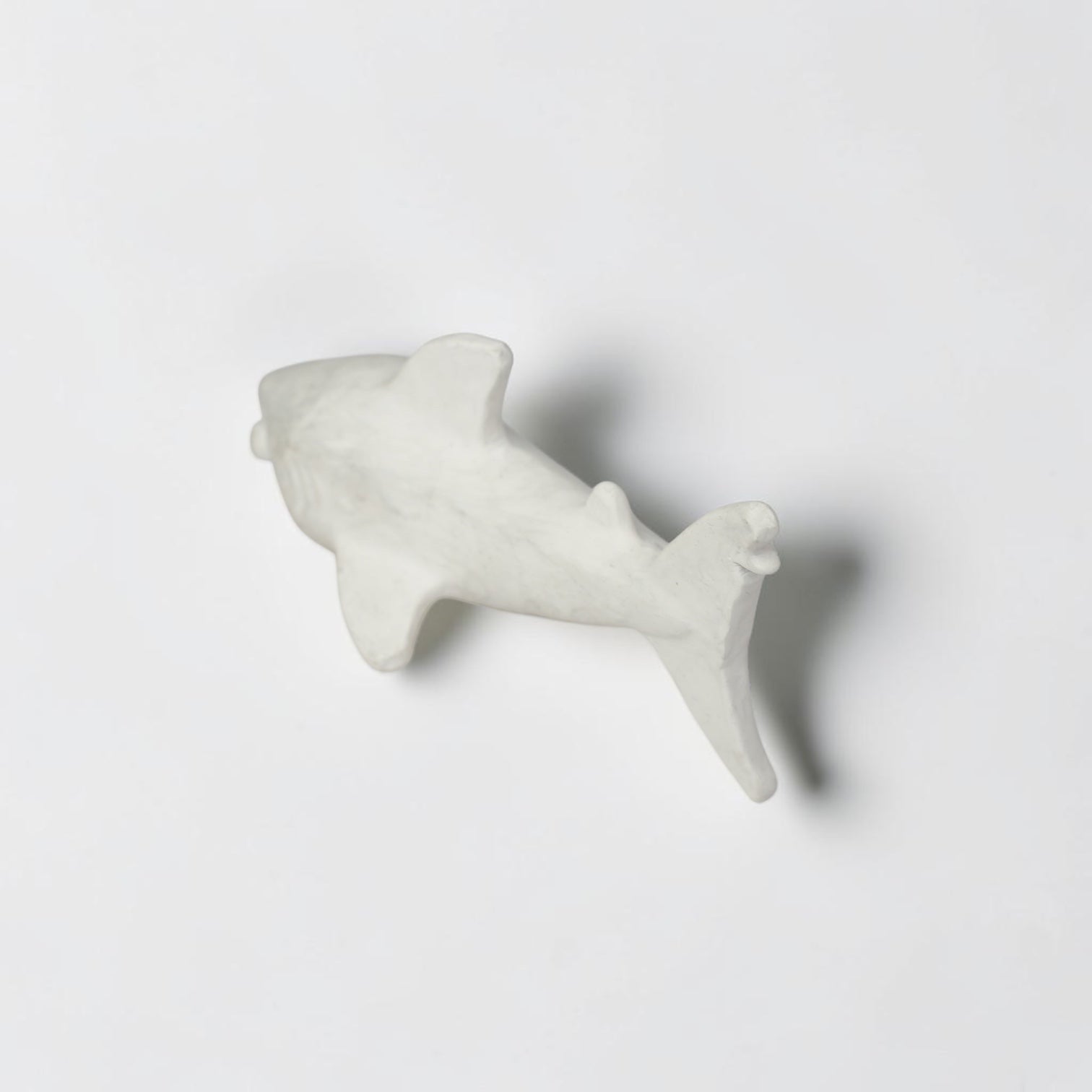 Outrageous Art minimalist matte white shark sculpture with a sleek silhouette for coastal home decor.