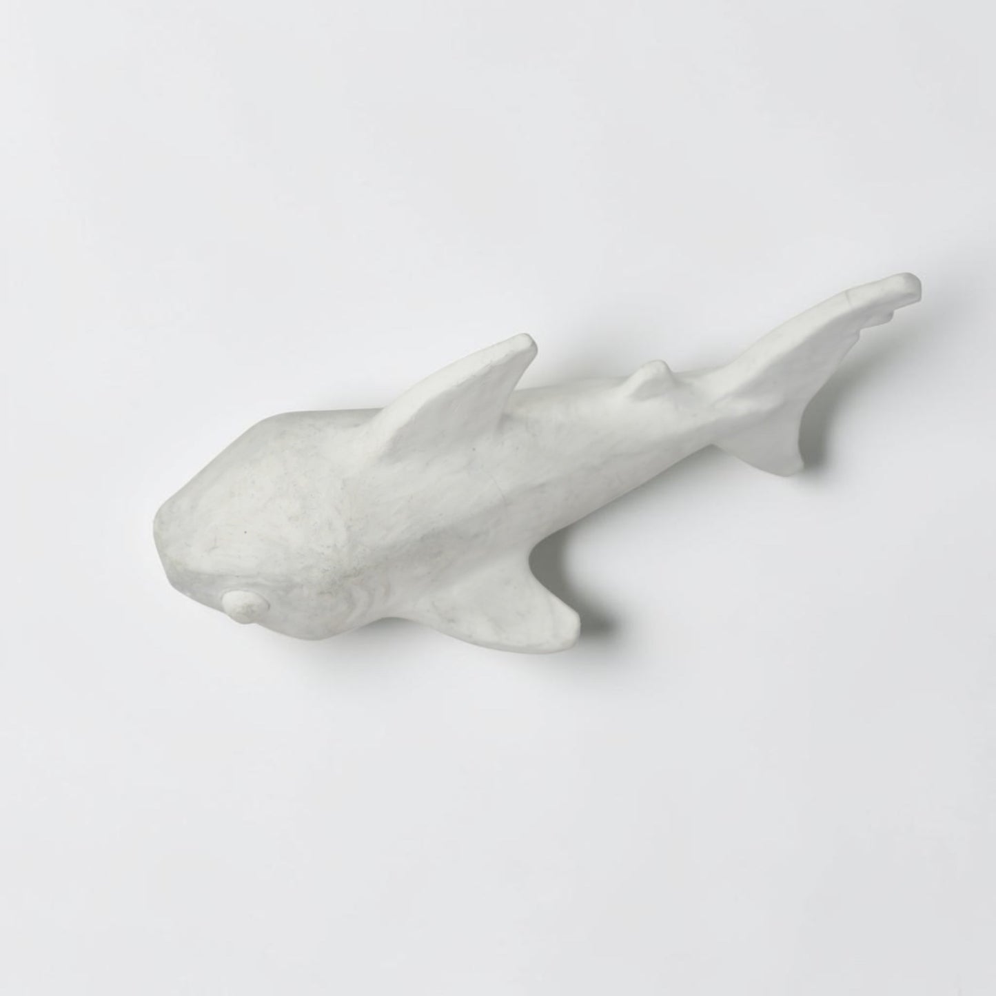 Outrageous Art minimalist shark sculpture in matte white, featuring a sleek handcrafted silhouette for coastal decor.
