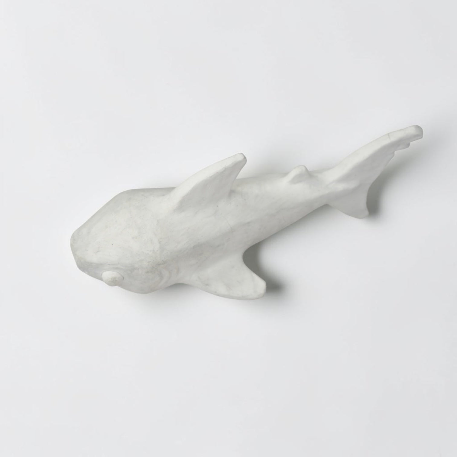 Outrageous Art minimalist shark sculpture in matte white, featuring a sleek handcrafted silhouette for coastal decor.
