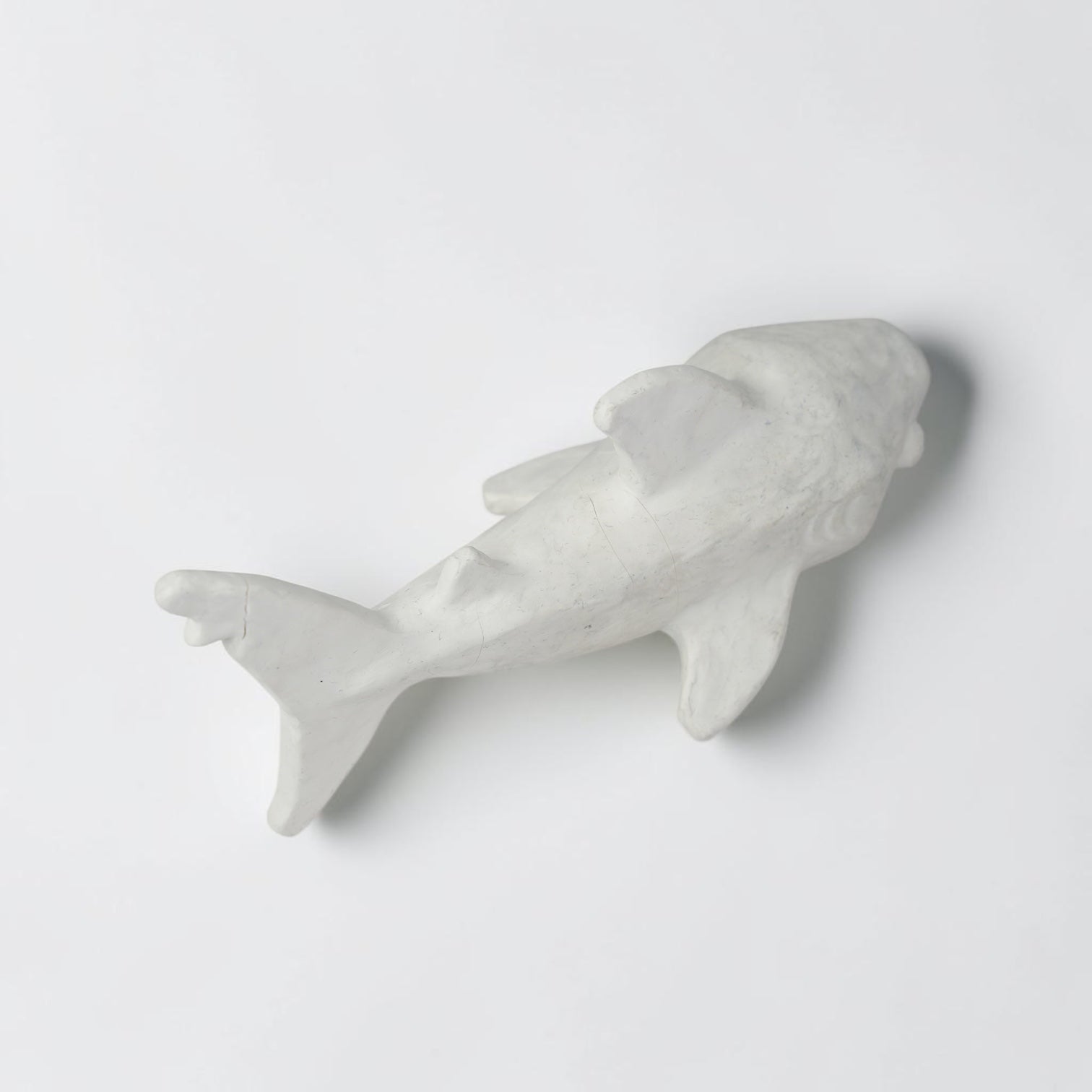 Outrageous Art handcrafted matte white shark sculpture with a minimalist silhouette for coastal home decor.