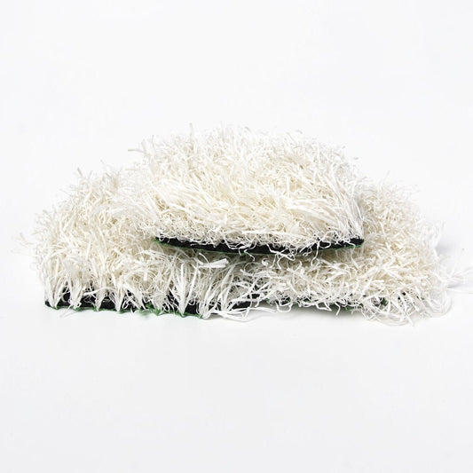 Outrageous Art white synthetic grass turf tiles with dense, realistic fibers and a sturdy black backing.