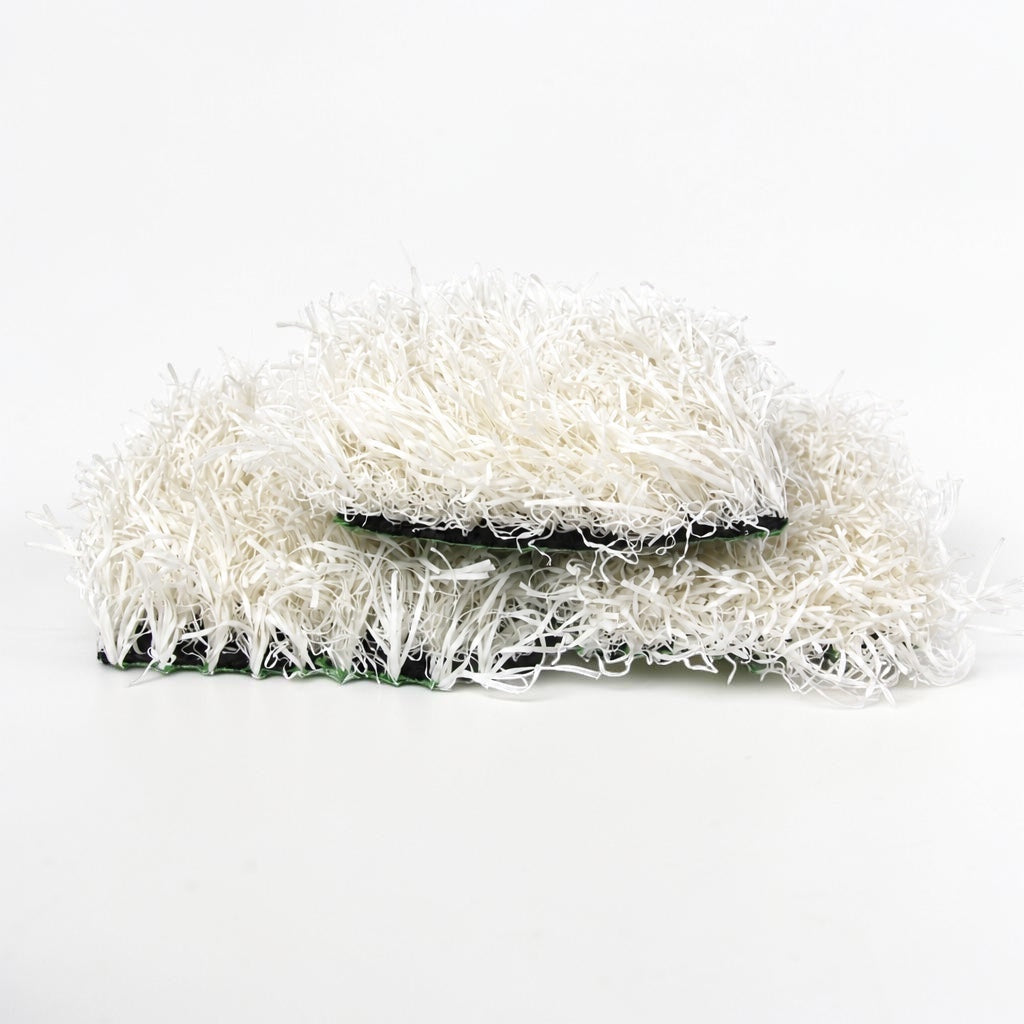 Outrageous Art white synthetic grass turf tiles with dense, realistic fibers and a sturdy black backing.