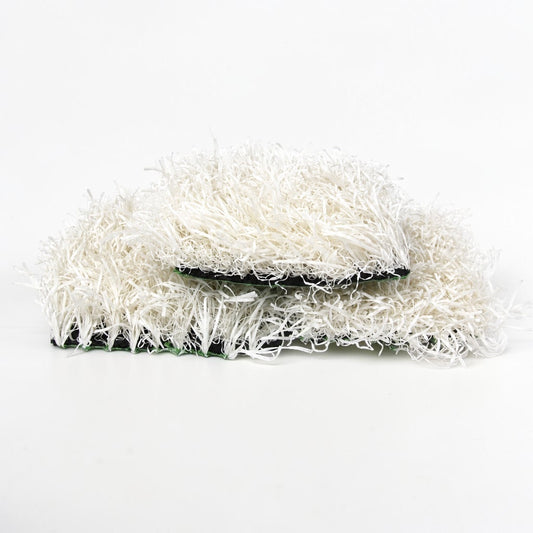 Outrageous Art white synthetic grass turf tiles with dense, realistic fibers and a sturdy black backing.