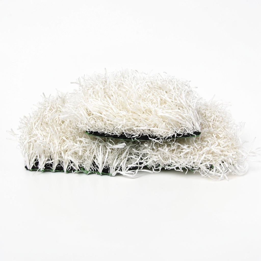 Outrageous Art white synthetic grass turf tiles with dense, realistic fibers and a sturdy black backing.