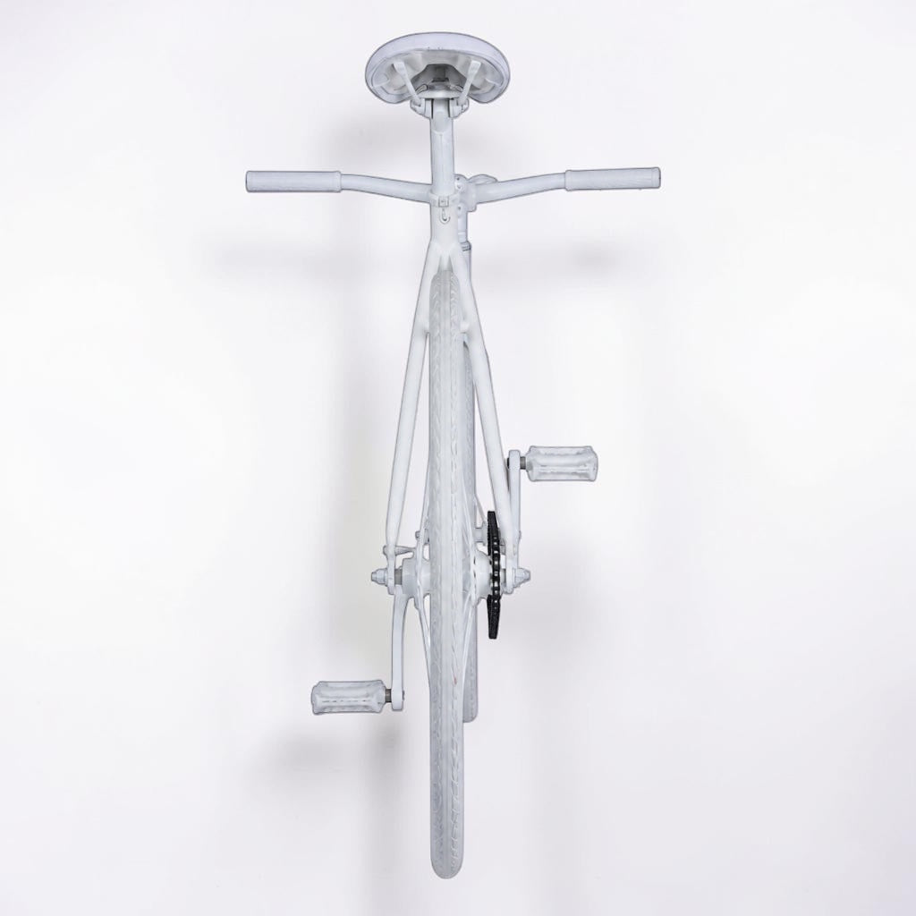 Outrageous Art velvet-covered white bicycle viewed from the rear, showcasing a unique plush fabric texture.